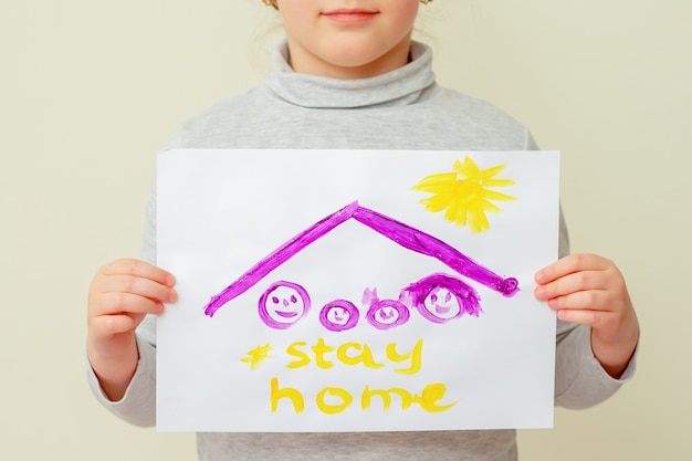 Child is holding picture of family.