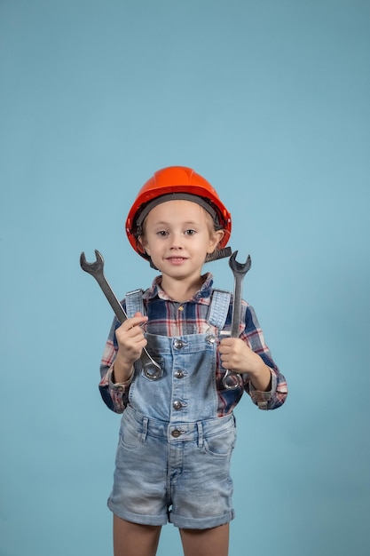 Child is holding wrenches. construction and repair concept. a
little girl is holding an adjustable tool in her hands.