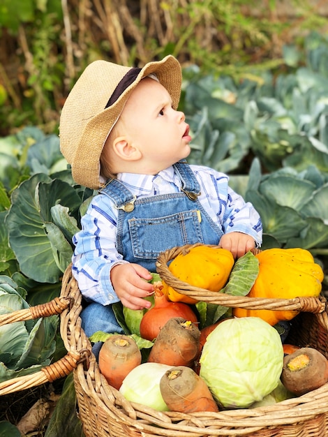 The child is a little farmer. Farm assistant.