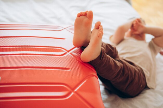 A child is lying on a red foam pad with the word " on it " on it.