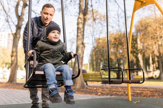 Child is playing on the swing