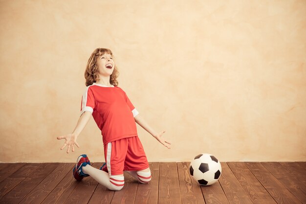 Child is pretending to be a soccer player Success and winner concept