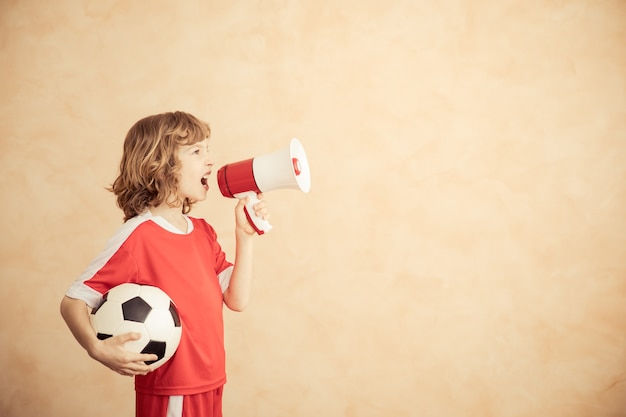 Child is pretending to be a soccer player Success and winner concept