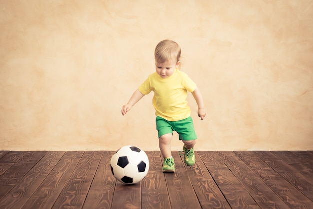 Child is pretending to be a soccer player. Success and winner concept