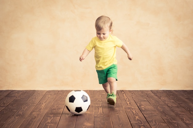 Child is pretending to be a soccer player. Success and winner concept