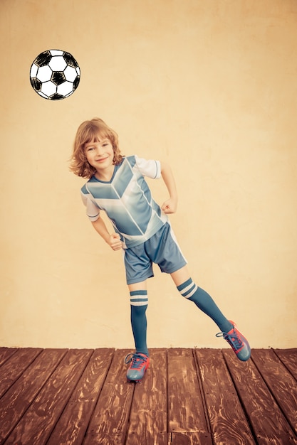 Child is pretending to be a soccer player. Success and winner concept