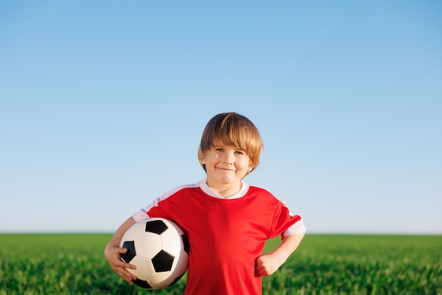 Child is pretending to be a soccer player