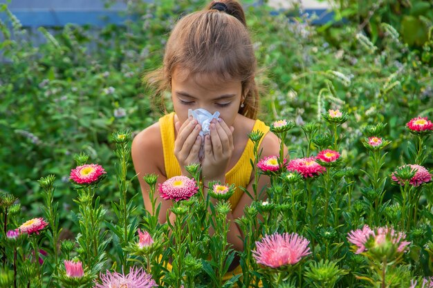 The child is seasonal allergy to flowers. Selective focus.