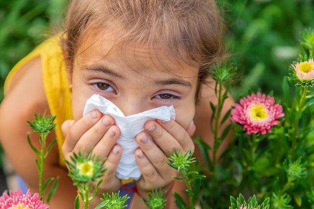 The child is seasonal allergy to flowers. Selective focus.