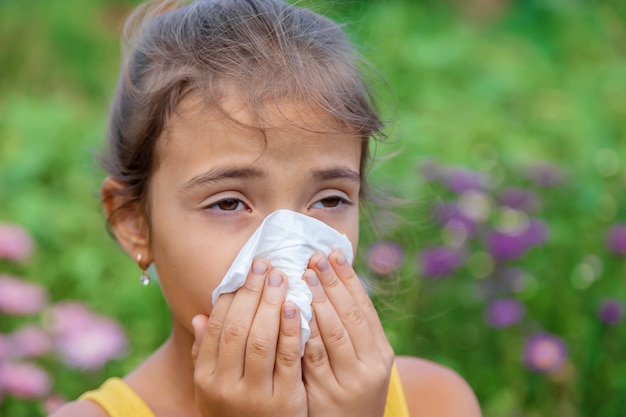 The child is seasonal allergy to flowers. Selective focus.