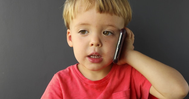 Child is talking on cell phone