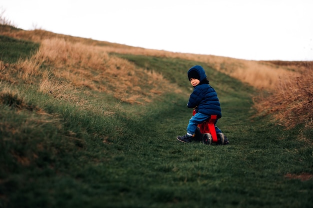 The child is traveling. Boy on a tricycle in the mountain. family travel