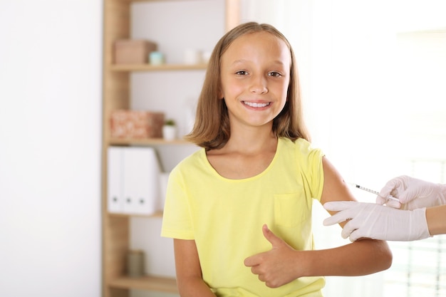 The child is vaccinated by a doctor