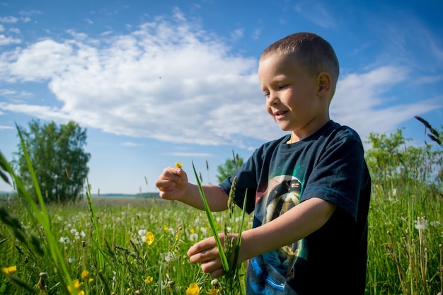 The child is walking in the meadow.