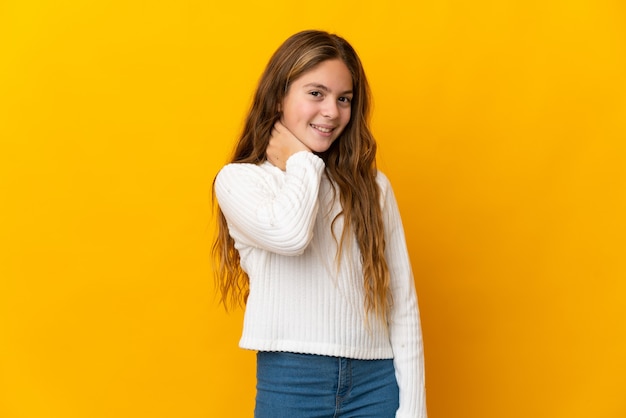 Child over isolated yellow background laughing