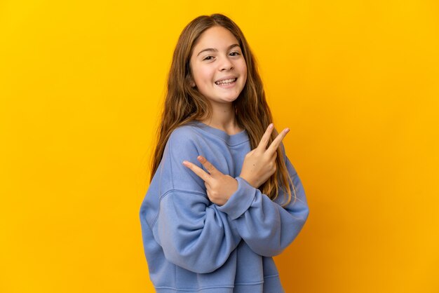 Child over isolated yellow background