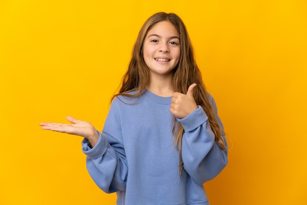 Child over isolated yellow background