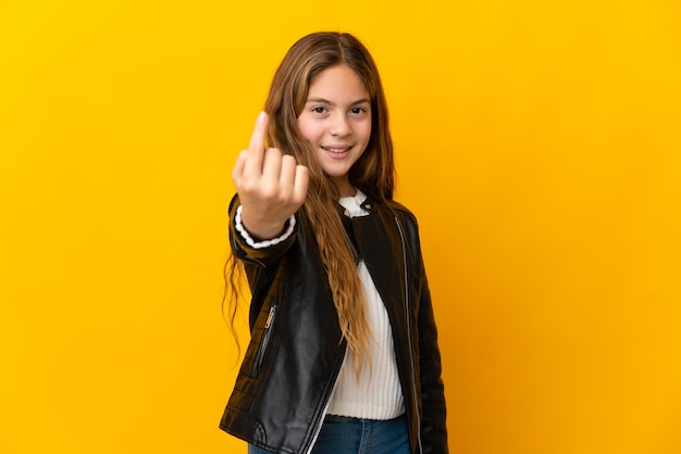 Child over isolated yellow doing coming gesture