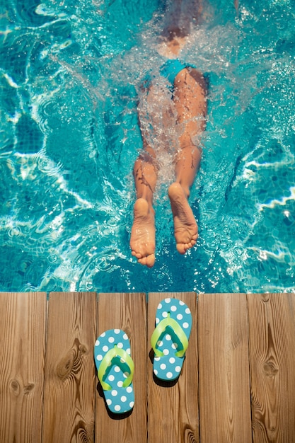 Child jumping in swimming pool