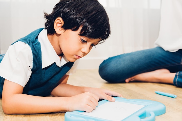 Child kid boy kindergarten education drawing at interior room home