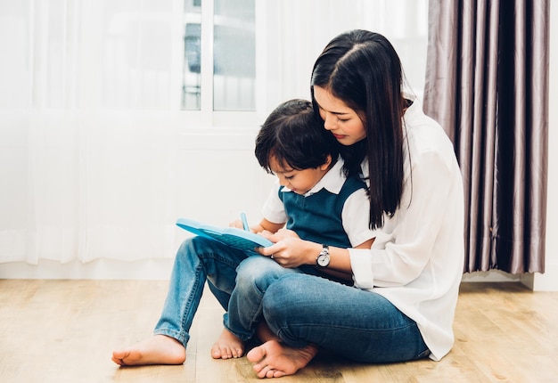 Child kid boy son kindergarten and beautiful mother teaching drawing together at interior room home