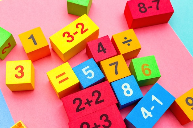 Photo child kid colorful education toys cubes with numbers. flat lay. childhood infancy children babies concept.