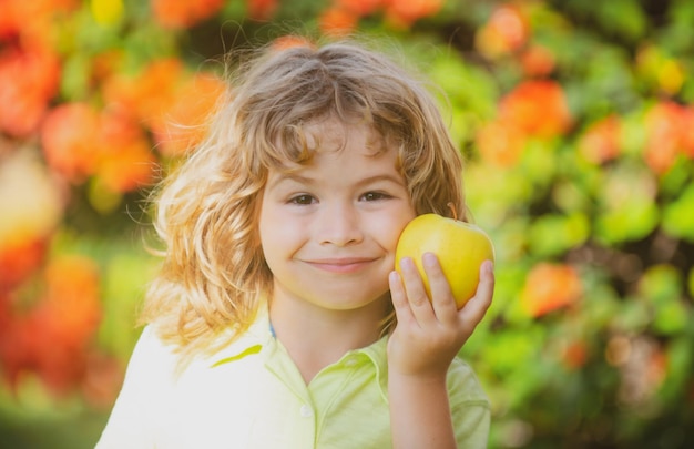 Child kid eating apple fruit outdoor autumn fall nature healthy outdoors.