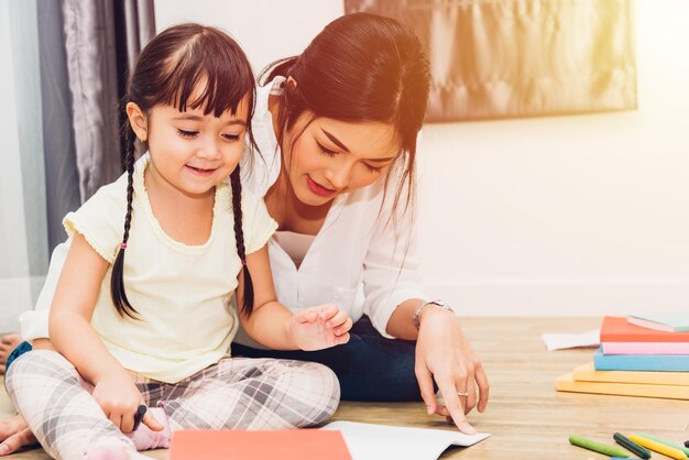 Child kid girl kindergarten drawing teacher education mother with beautiful mother at interior room home