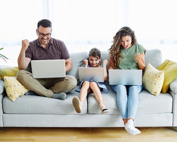 Photo child laptop family computer woman mother father happy home man technology daughter together internet