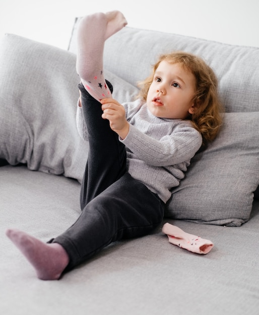 Child learning to put on socks