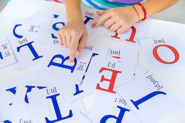 The child learns English letters Selective focus