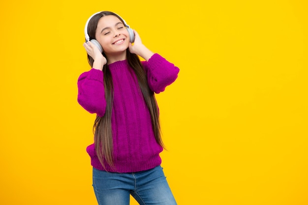 Child listening music with headphones Girl listening songs via wireless earphones Headset device accessory Stylish teenage girl listening to music