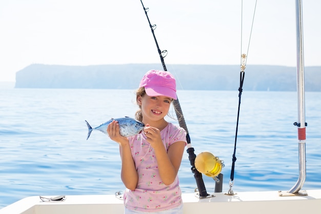 child little girl fishing in boat 