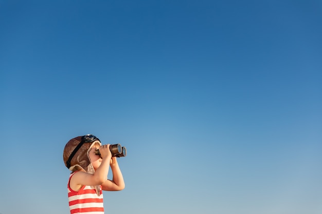 Child look through marine glasses. Kid having fun outdoor.