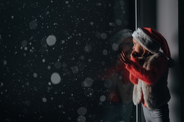 The child looks out the window on christmas of Jesus Christ.