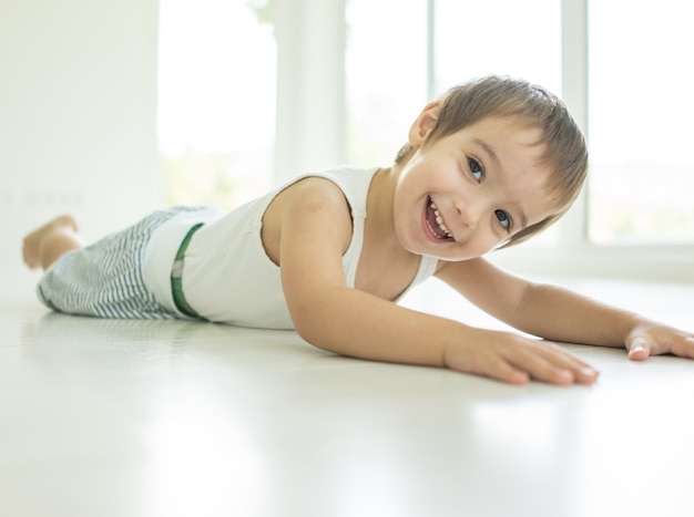 Child lying down on floor