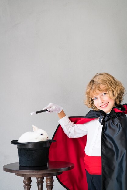 Child magician with cute rabbit.