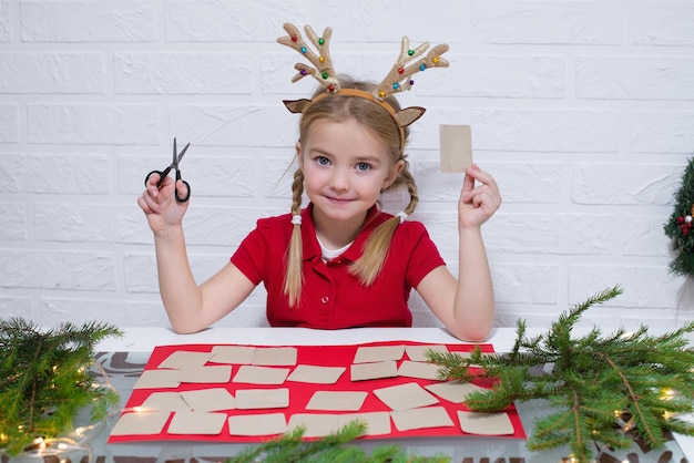 a child makes a handmade advent calendar out of cardboard family winter holidays for the new year