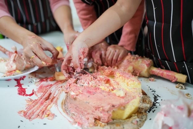 Child making cake with family family having fun together in kitchen