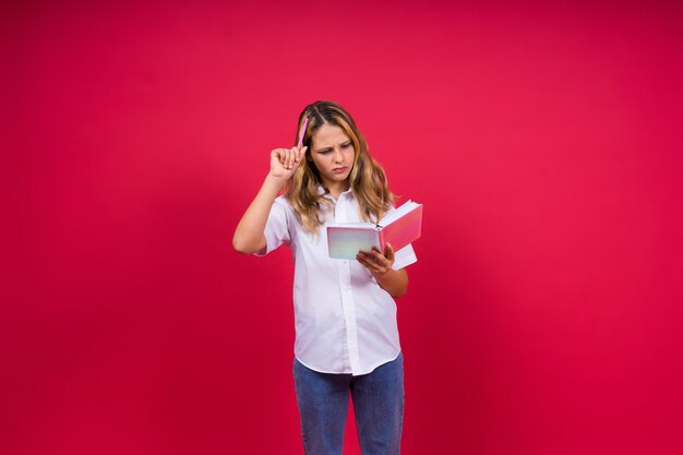 Child making notes kids dreamsisolated on red background education kid back to school