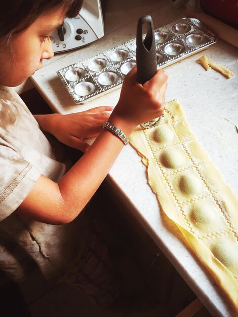 Photo child making ravioli