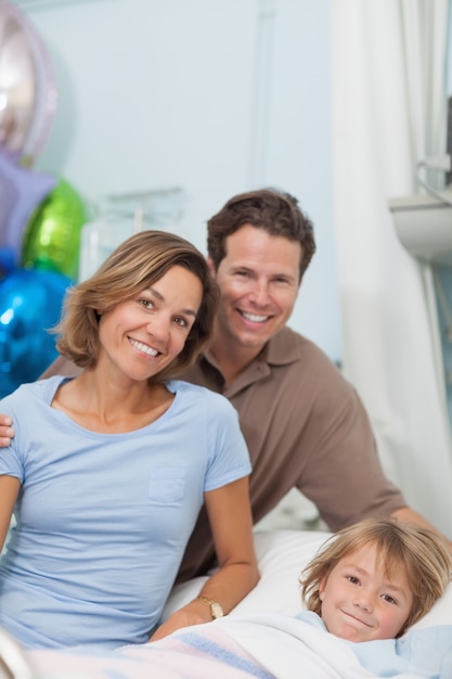 Child on a medical bed next to his parents