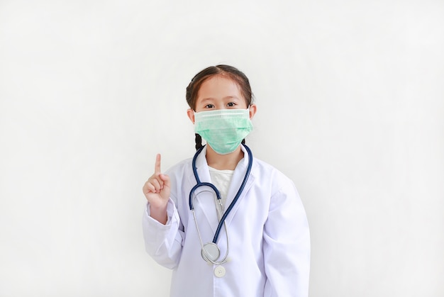Child in medical uniform showing one forefinger