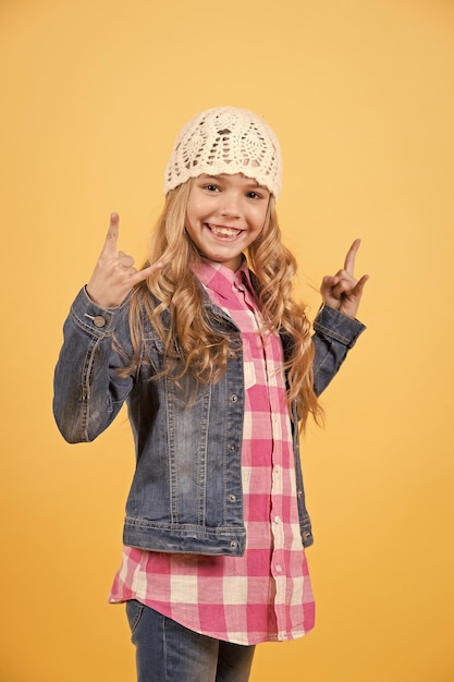 Child model in jeans suit hat smile with horn hands