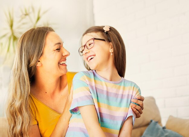 Child mother family parent home woman happy playing daughter kid together indoor hug hugging kiss