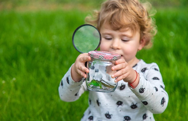 Child in nature with a lizard Selective focus