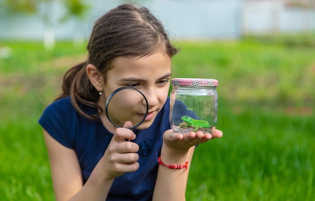 Child in nature with a lizard Selective focus