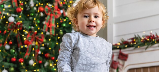 Child near the christmas tree Selective focus