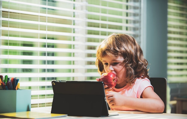 Child at online school home schooling coronavirus outbreak schoolboy watching online education class