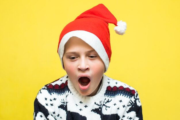 Child opened mouth in shock after seeing presents boy is ready for New Year celebrations Yellow